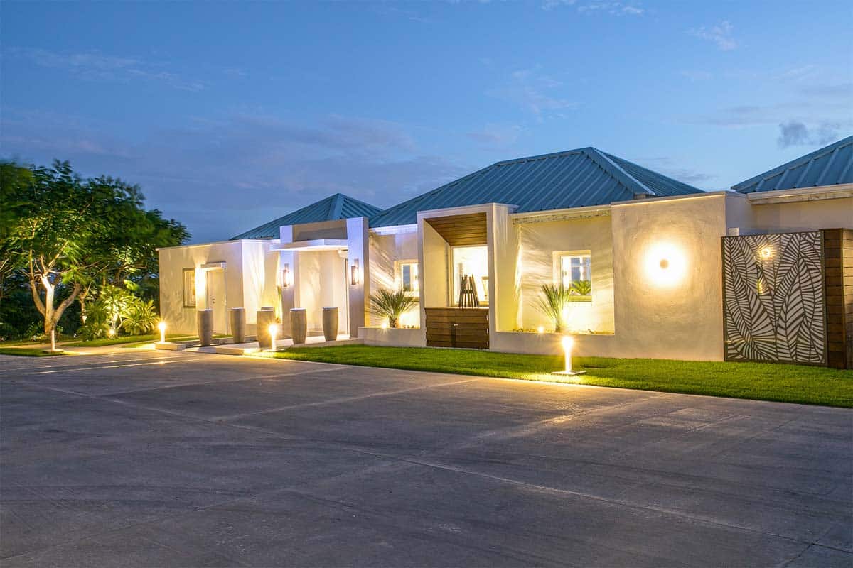 Main entrance of Villa Avanti featuring stone fountains and palm-lined driveway in Terres Basses, St. Martin.