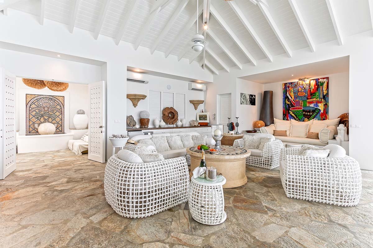 Spacious living room with high ceilings and natural stone floors at Villa L'Oasis, Terres Basses, St. Martin