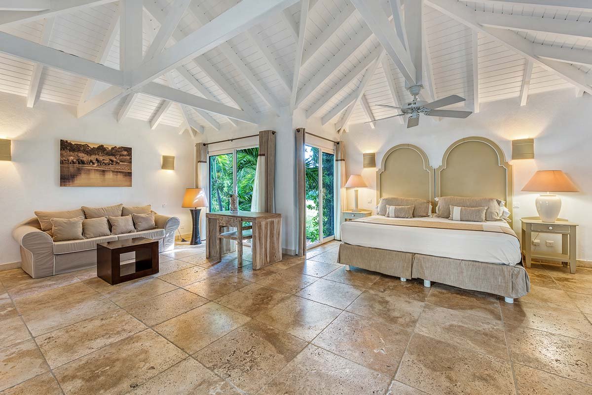 Bright bedroom interior at La Pinta villa, St. Maarten with garden view