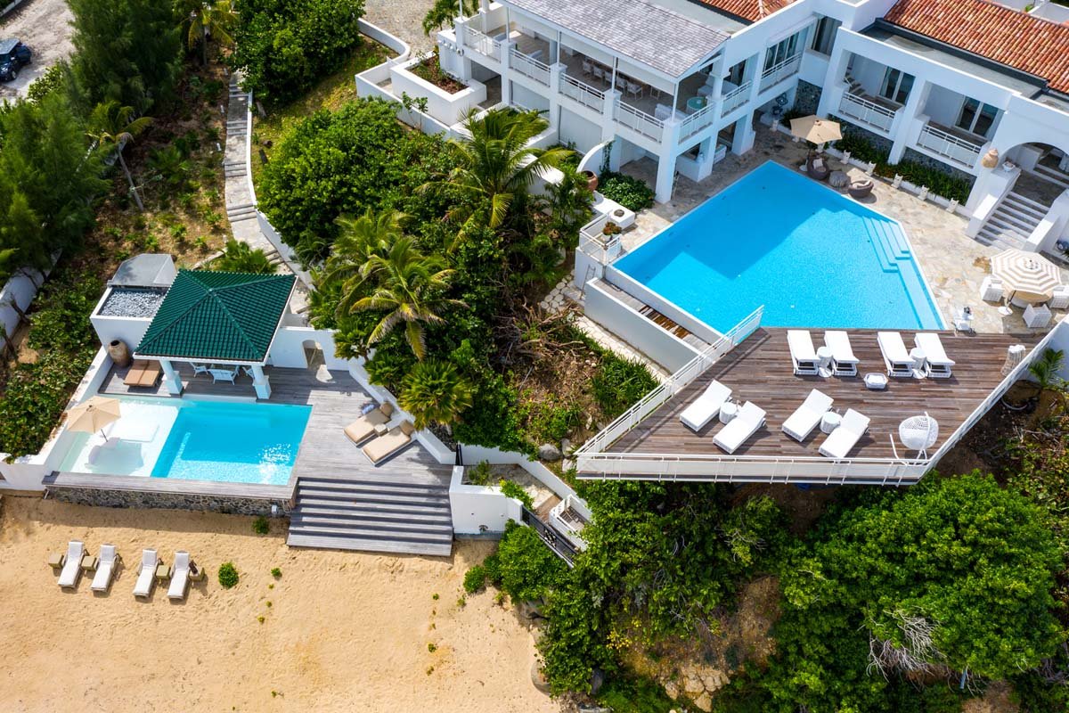 Dual pools at Villa L'Oasis: infinity-edge pool with sun deck and beachfront pool with daybeds, Terres Basses, St. Martin