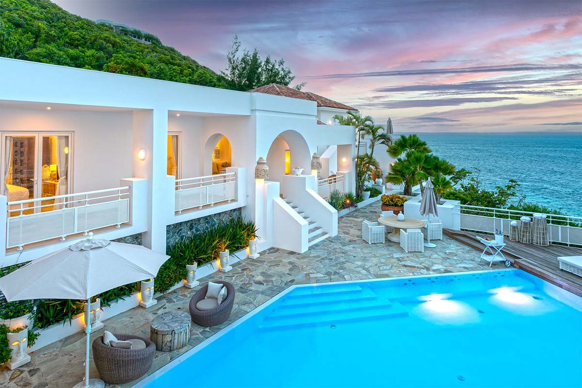 Villa L'Oasis illuminated at dusk, showcasing Moroccan-inspired architecture and ocean views, Terres Basses, St. Martin