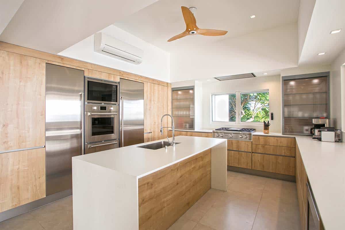 Modern kitchen with Wolf and Sub-Zero appliances, island, and breakfast bar at Villa Avanti, St. Martin.