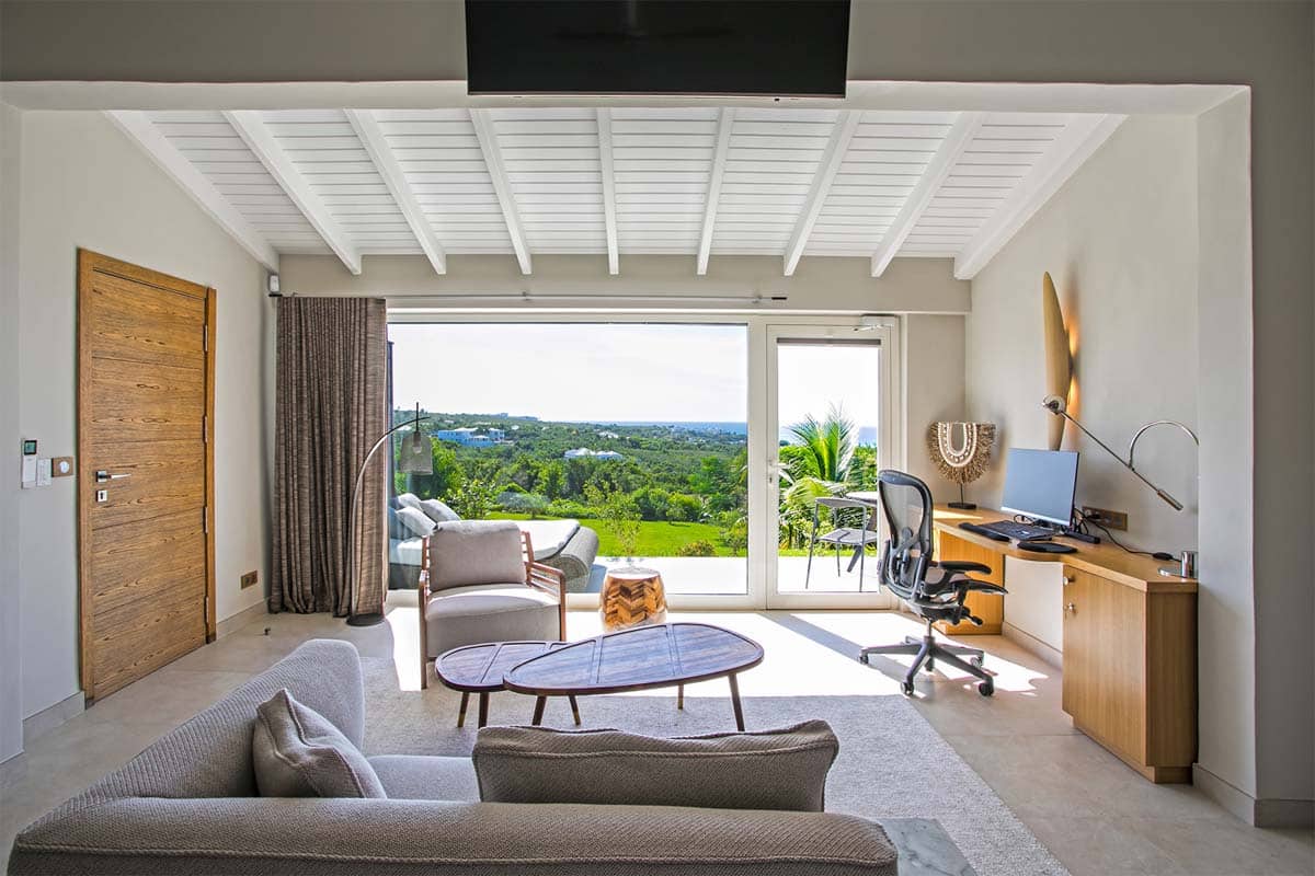 Master bedroom with king bed, private terrace, and ocean view at Villa Avanti, St. Martin.
