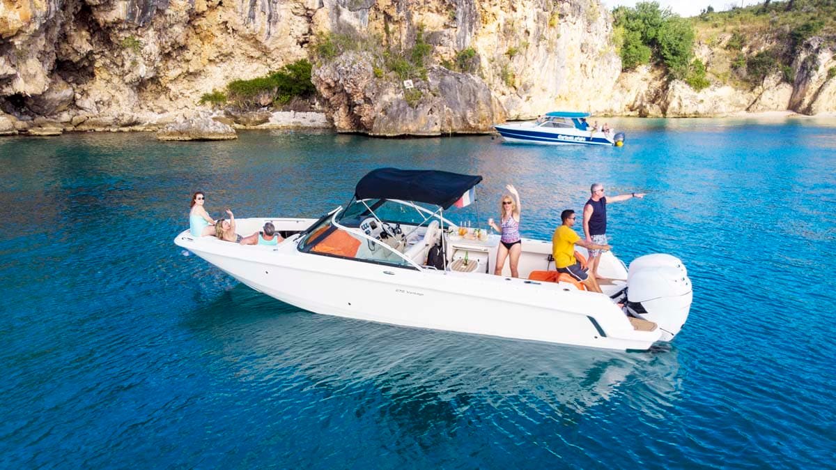 Side profile of a Boston Whaler center console boat, showcasing its open deck and durable design.