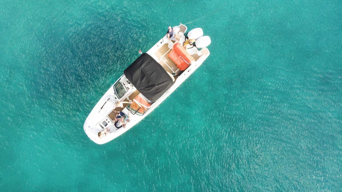 Boston Whaler center console boat cruising near St. Martin coastline, ideal for private charters.
