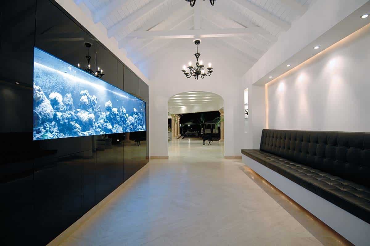 Sandyline Estate's aquarium feature in Terres Basses, St. Martin, showcasing a modern design with tropical fish.