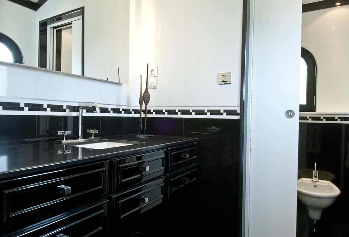 Sandyline Estate's luxurious bath and office area in Terres Basses, St. Martin, featuring a spacious outdoor lounge and tropical landscaping