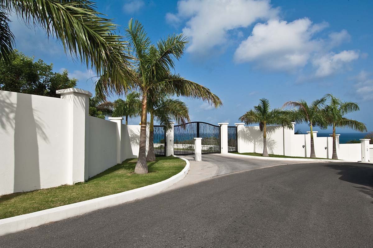 Palm-lined driveway leading to Sandyline Estate entrance in Terres Basses, St. Martin