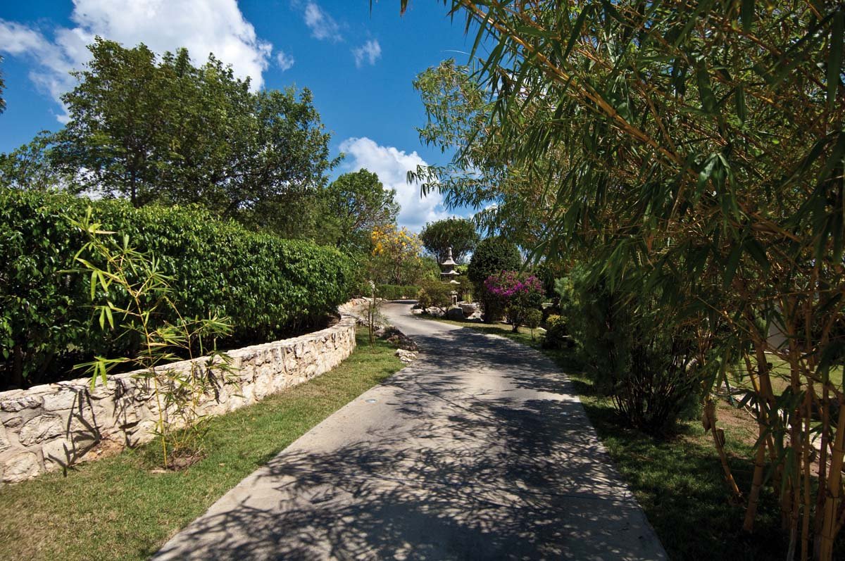 Lush tropical garden with koi pond and running streams at Villa Sandyline, Terres Basses, St. Martin
