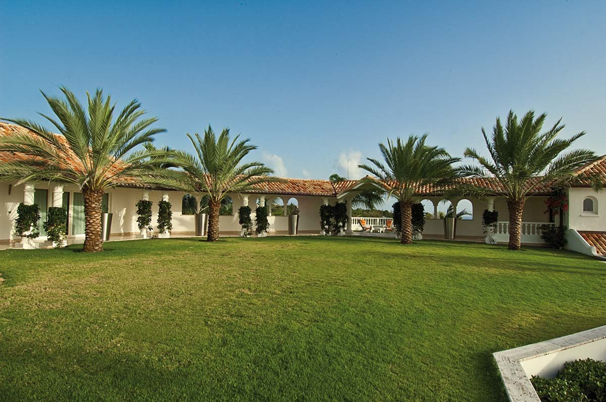 Tranquil koi pond surrounded by lush tropical foliage at Villa Sandyline, Terres Basses, St. Martin