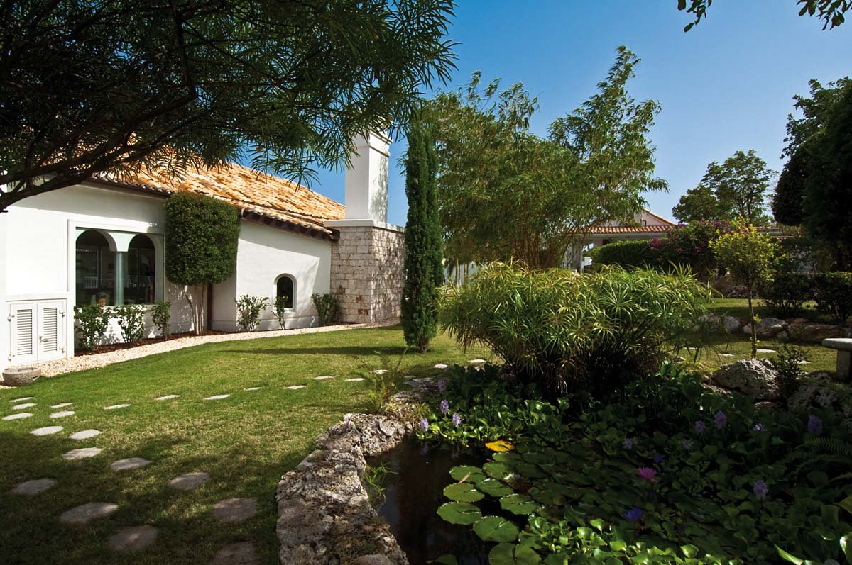 Lush tropical garden with koi pond and running streams at Villa Sandyline, Terres Basses, St. Martin