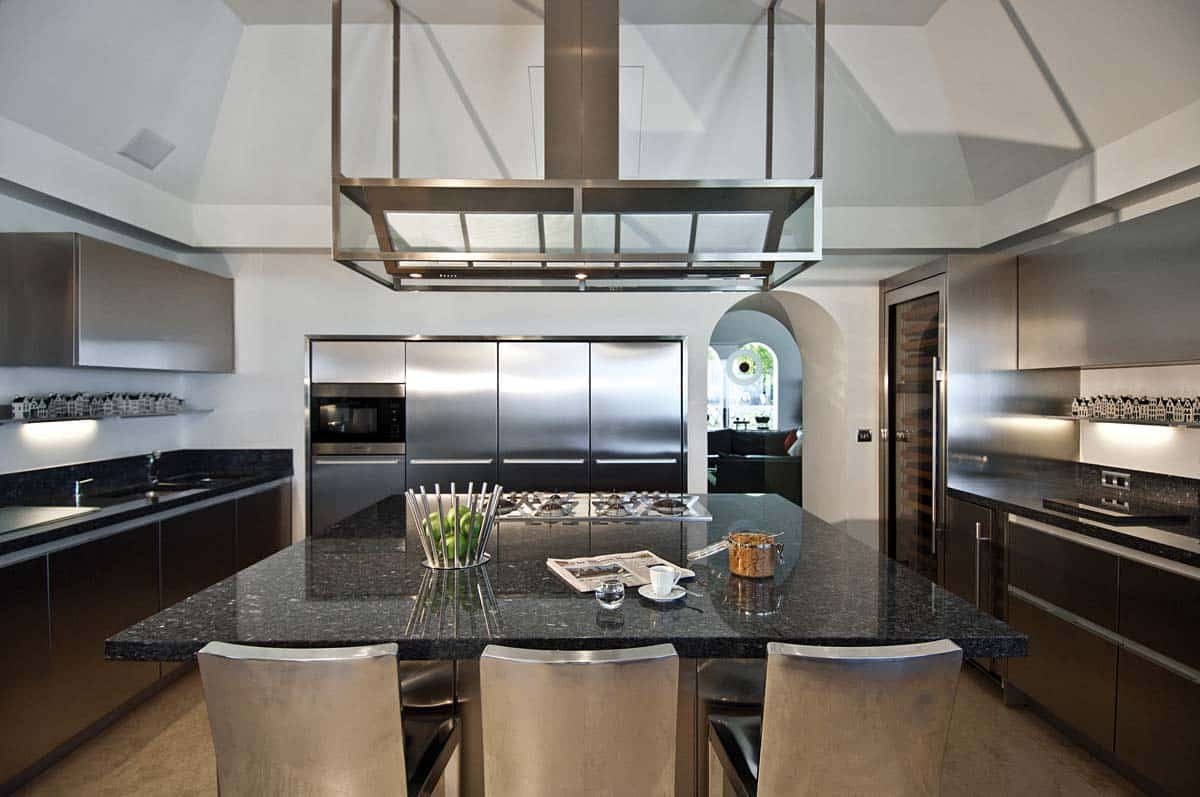 Modern kitchen with stainless steel appliances, espresso machine, and ocean view at Villa Sandyline, Terres Basses, St. Martin