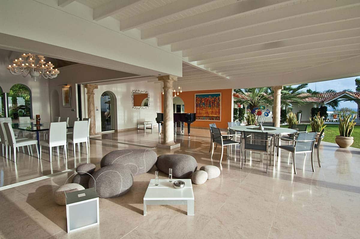 Spacious living room with leather sofas, home cinema, and ocean view at Villa Sandyline, Terres Basses, St. Martin