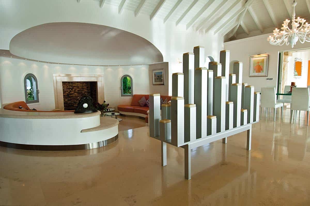 Spacious living room with leather sofas, home cinema, and ocean view at Villa Sandyline, Terres Basses, St. Martin