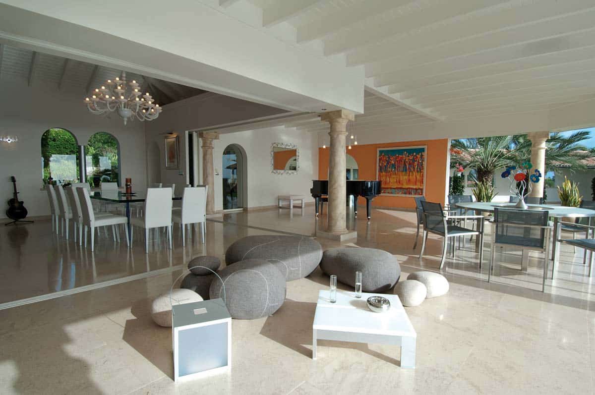 Spacious living room with leather sofas, home cinema, and ocean view at Villa Sandyline, Terres Basses, St. Martin