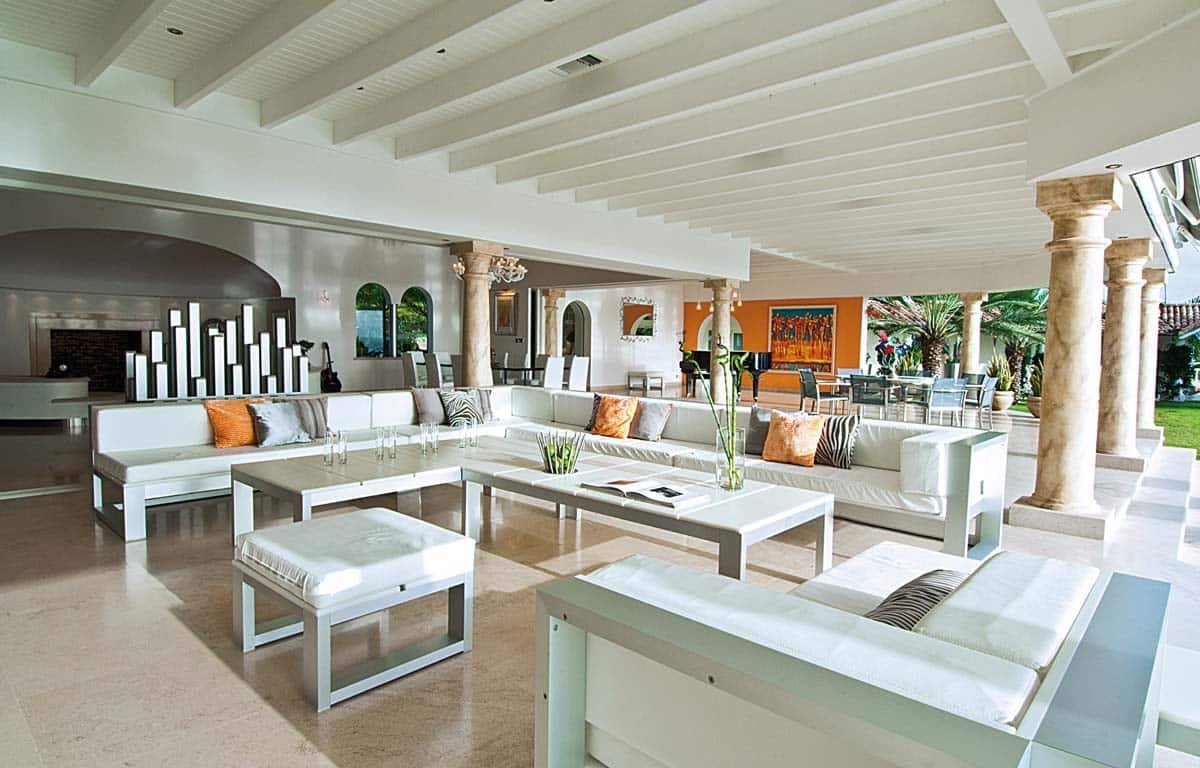 Spacious living room with leather sofas, home cinema, and ocean view at Villa Sandyline, Terres Basses, St. Martin