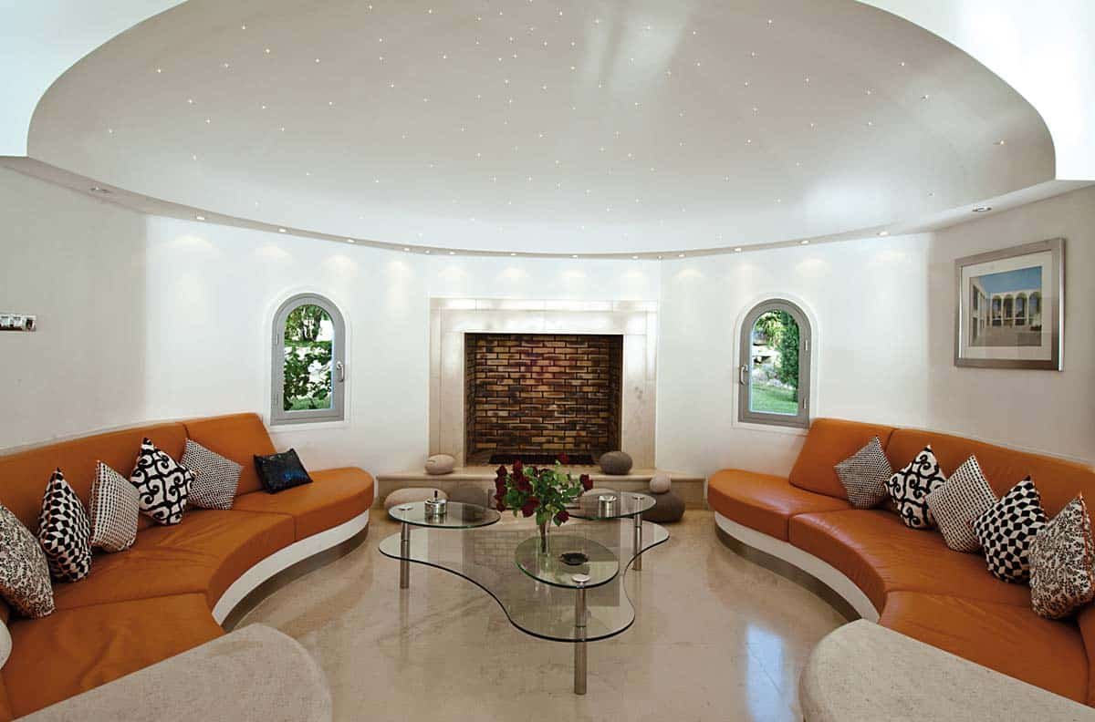 Spacious living room with leather sofas, home cinema, and ocean view at Villa Sandyline, Terres Basses, St. Martin