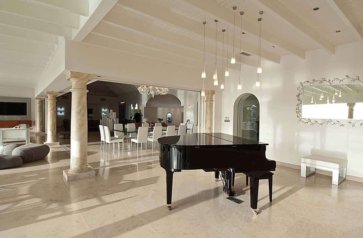 Spacious living room with leather sofas, home cinema, and ocean view at Villa Sandyline, Terres Basses, St. Martin