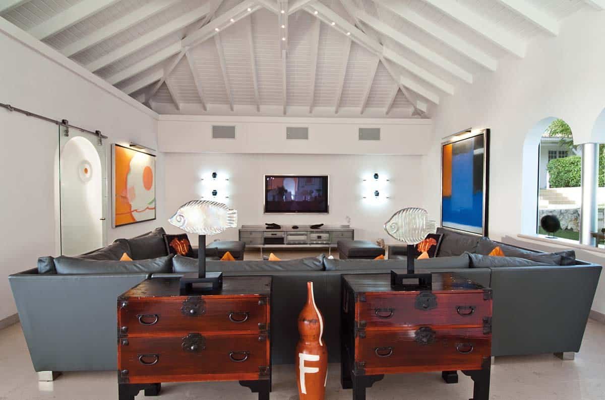 Spacious living room with leather sofas, home cinema, and ocean view at Villa Sandyline, Terres Basses, St. Martin