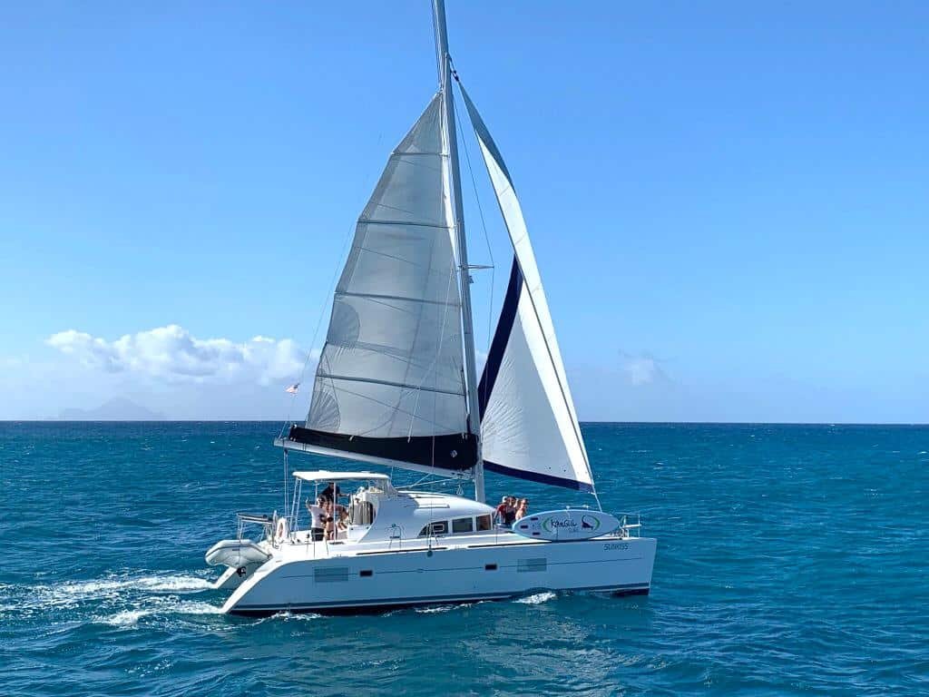38-ft catamaran sailing on clear Caribbean sea, luxury charter in St. Maarten