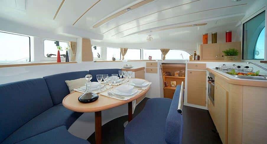 Intimate dining table and lounge in catamaran salon, luxury charter in St. Maarten