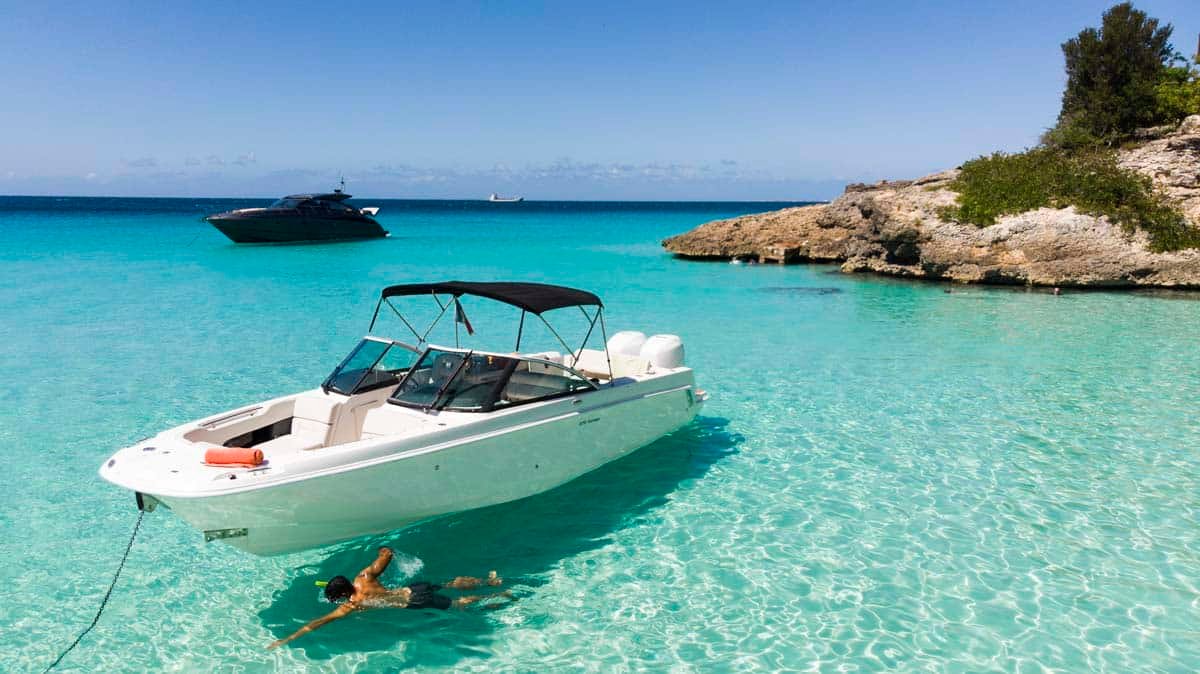Swimmer enjoying crystal-clear waters at Orient Bay Beach, St. Martin