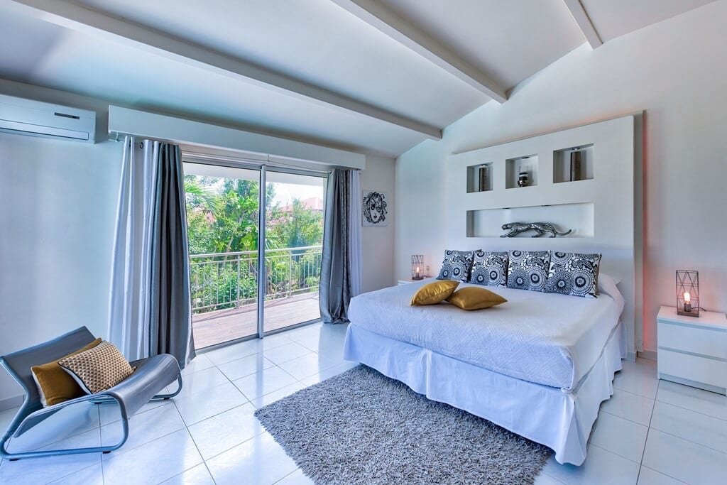 African" bedroom with king-size bed and contemporary decor at Villa Paloma, Orient Bay, St. Martin.