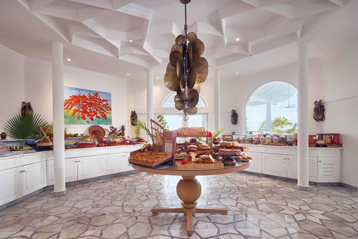 Morning beachside breakfast table under sun-shade, resort dining in St. Maarten
