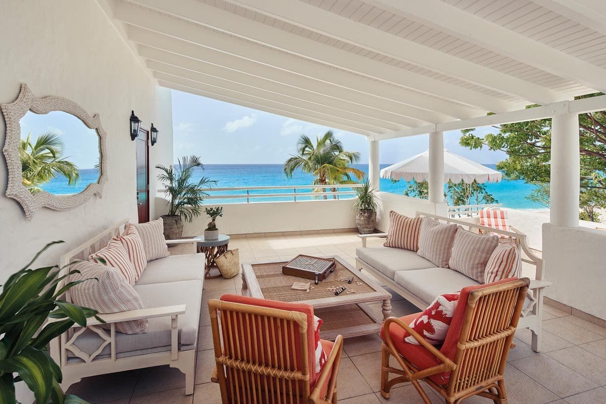Bright luxury suite interior with open doors facing pool, resort stay in St. Maarten