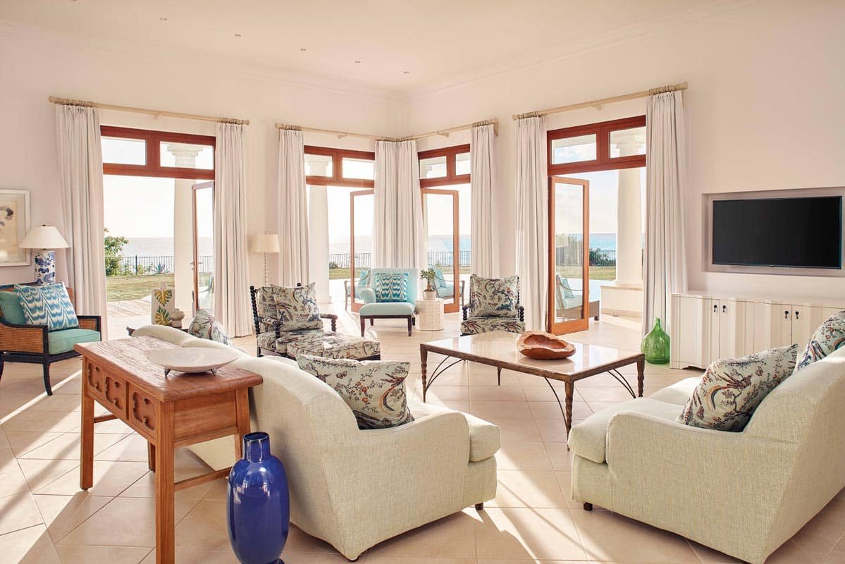 Signature Villa at Belmond La Samanna, featuring a spacious living area, private infinity pool, and panoramic views of Baie Longue Beach.