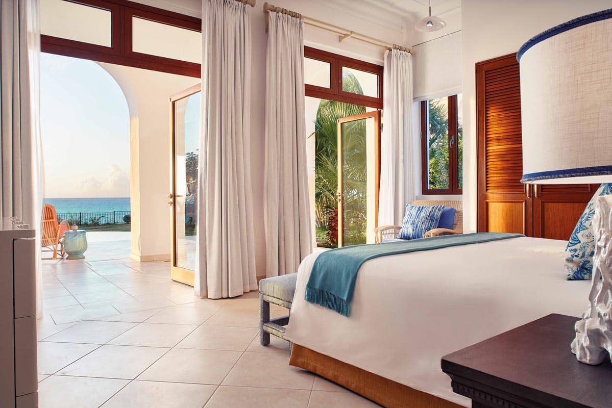 Signature Villa at Belmond La Samanna, featuring a spacious living area, private infinity pool, and panoramic views of Baie Longue Beach.