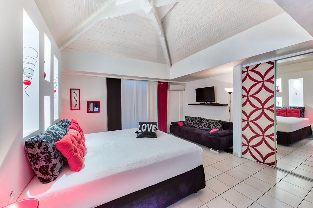 Love" bedroom with king-size bed and decorative mirror at Villa Paloma, Orient Bay, St. Martin.