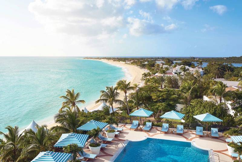 Pool edge overlooking white-sand beach and turquoise ocean, Belmond La Samanna, St. Maarten
