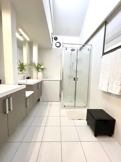 Elegant bathroom with dual sinks and modern fixtures in the African Room at Villa Paloma, Orient Bay, St. Martin.