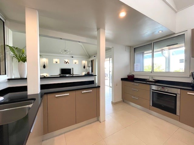 Spacious kitchen with granite countertops and modern appliances at Villa Paloma, Orient Bay, St. Martin.