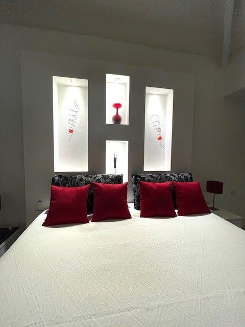 Romantic bedroom at Villa Paloma, Orient Bay—king-size bed, private terrace, and lush tropical garden