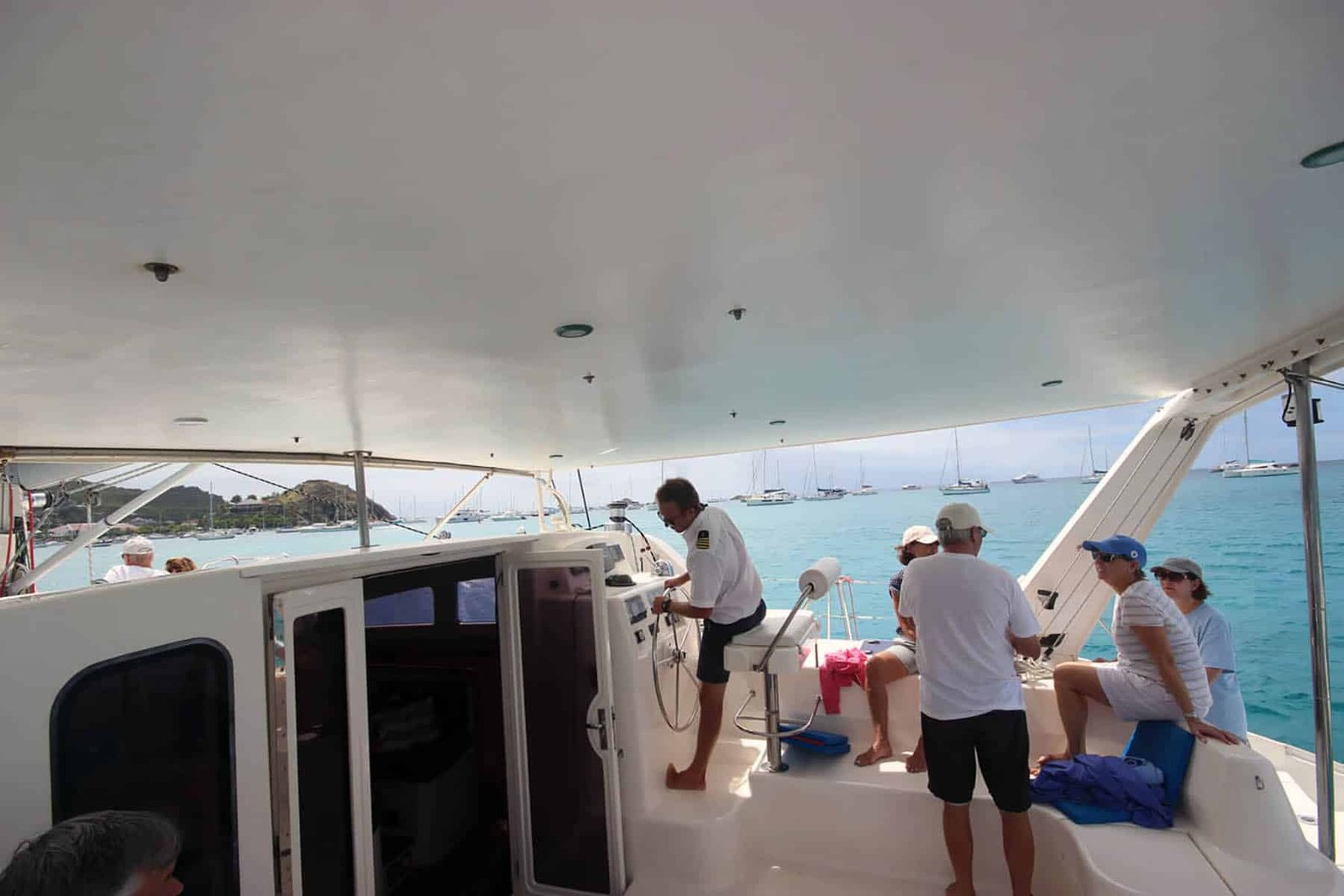 Seaduction catamaran cockpit: guests seated behind captain, Philipsburg, St. Martin