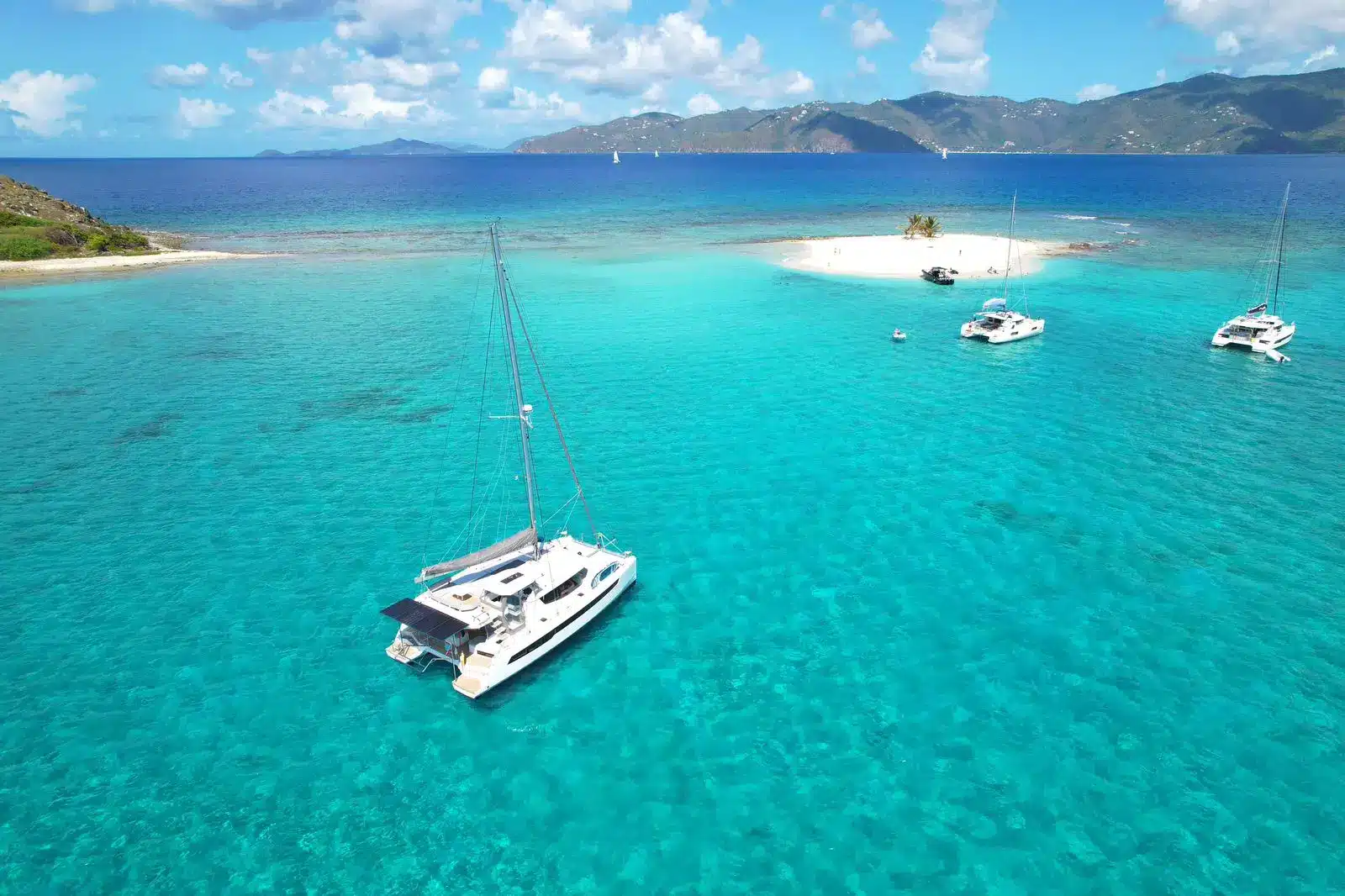 Aerial view of the Leopard 45 sail catamaran cruising turquoise waters off St. Maarten