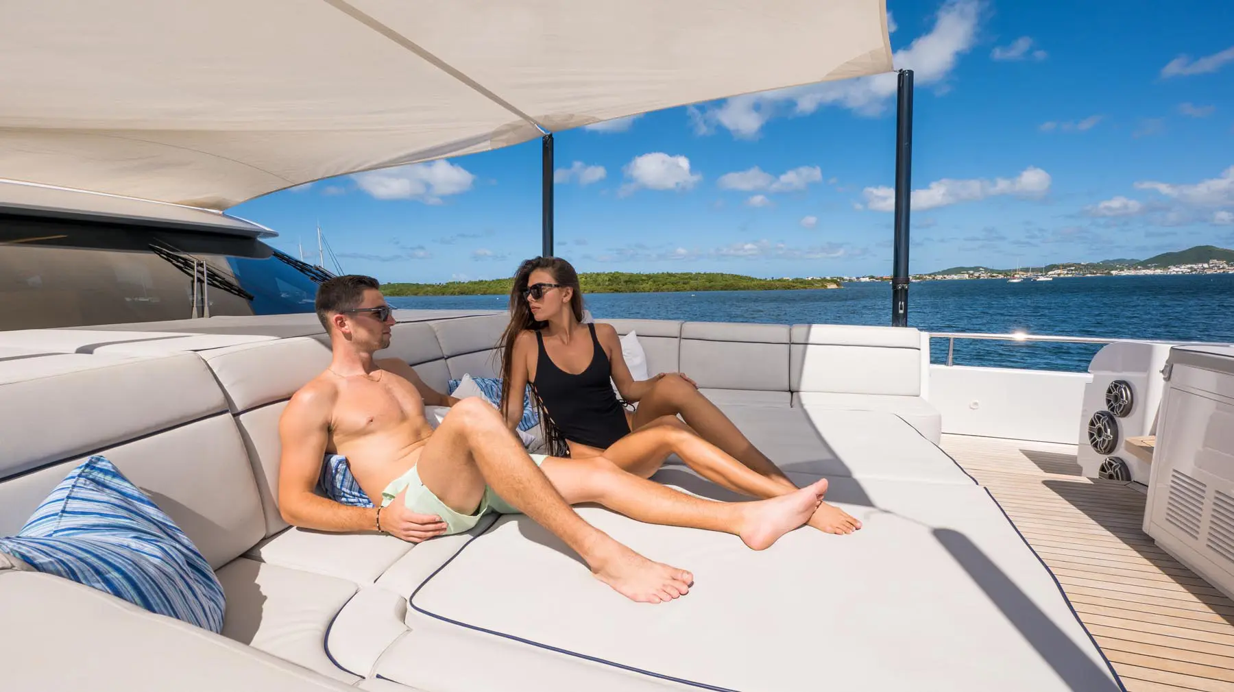 Luxury yacht deck seating and railing, sunset over sea in St. Maarten