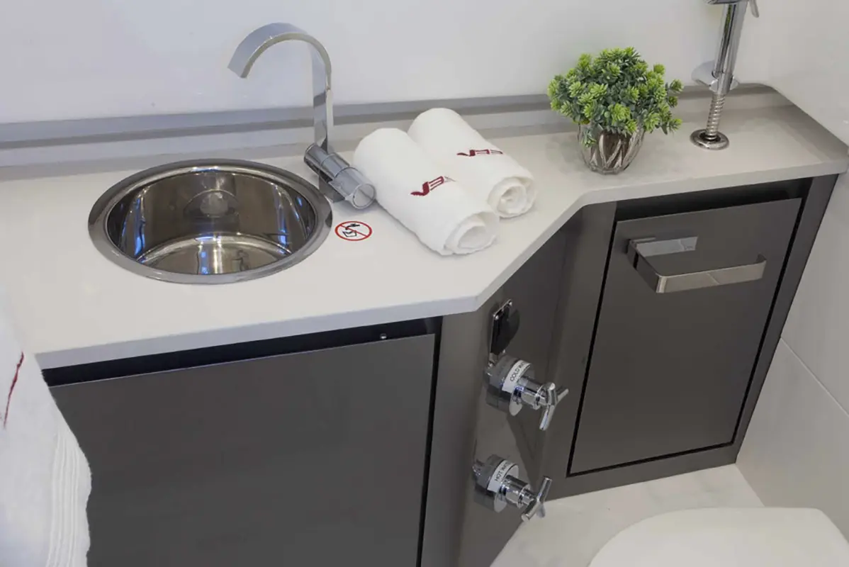 Sleek, modern bathroom aboard the Stellar 34ft yacht, featuring a shower, sink, and storage.