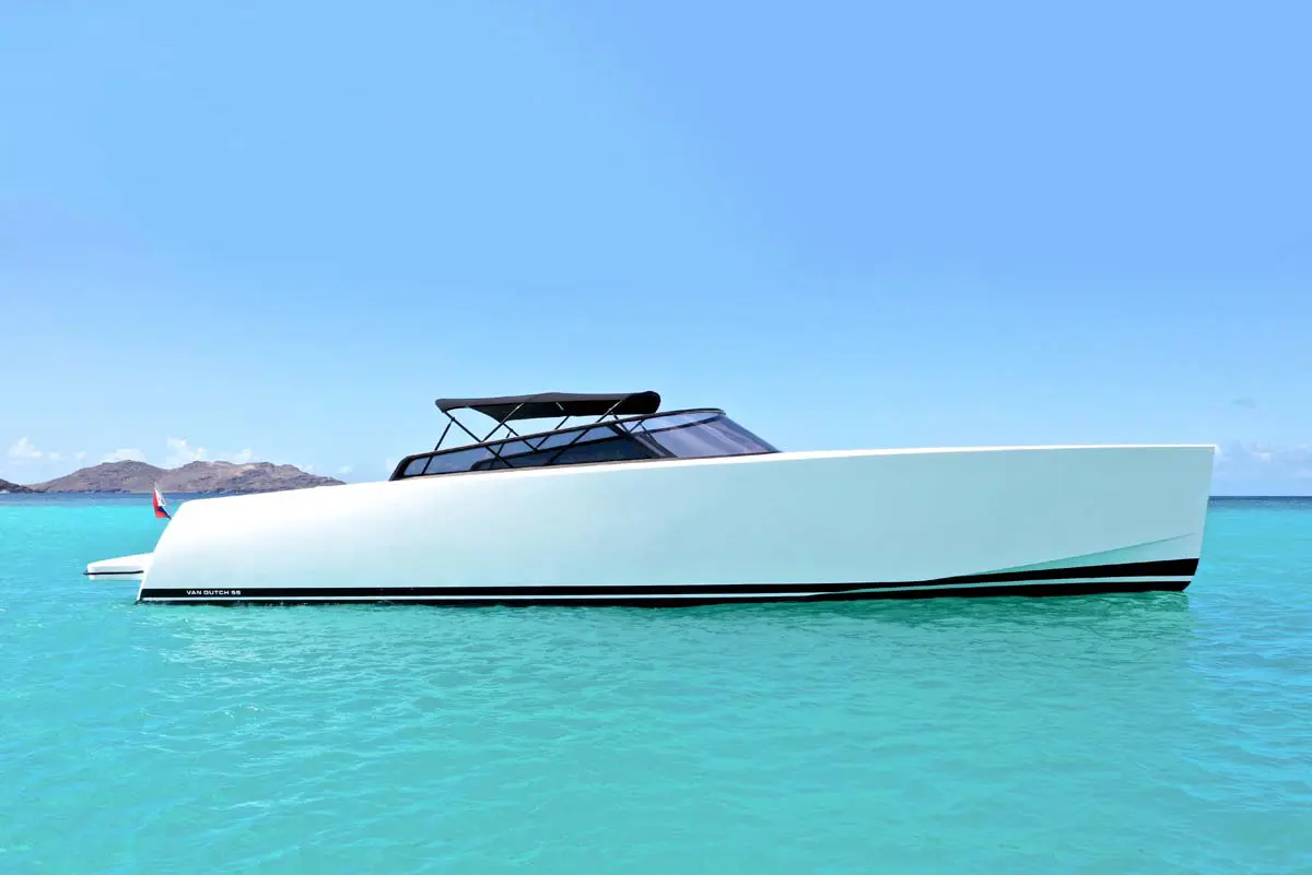 VanDutch 55 yacht cruising near St. Maarten's coastline, showcasing its sleek design and luxury features.