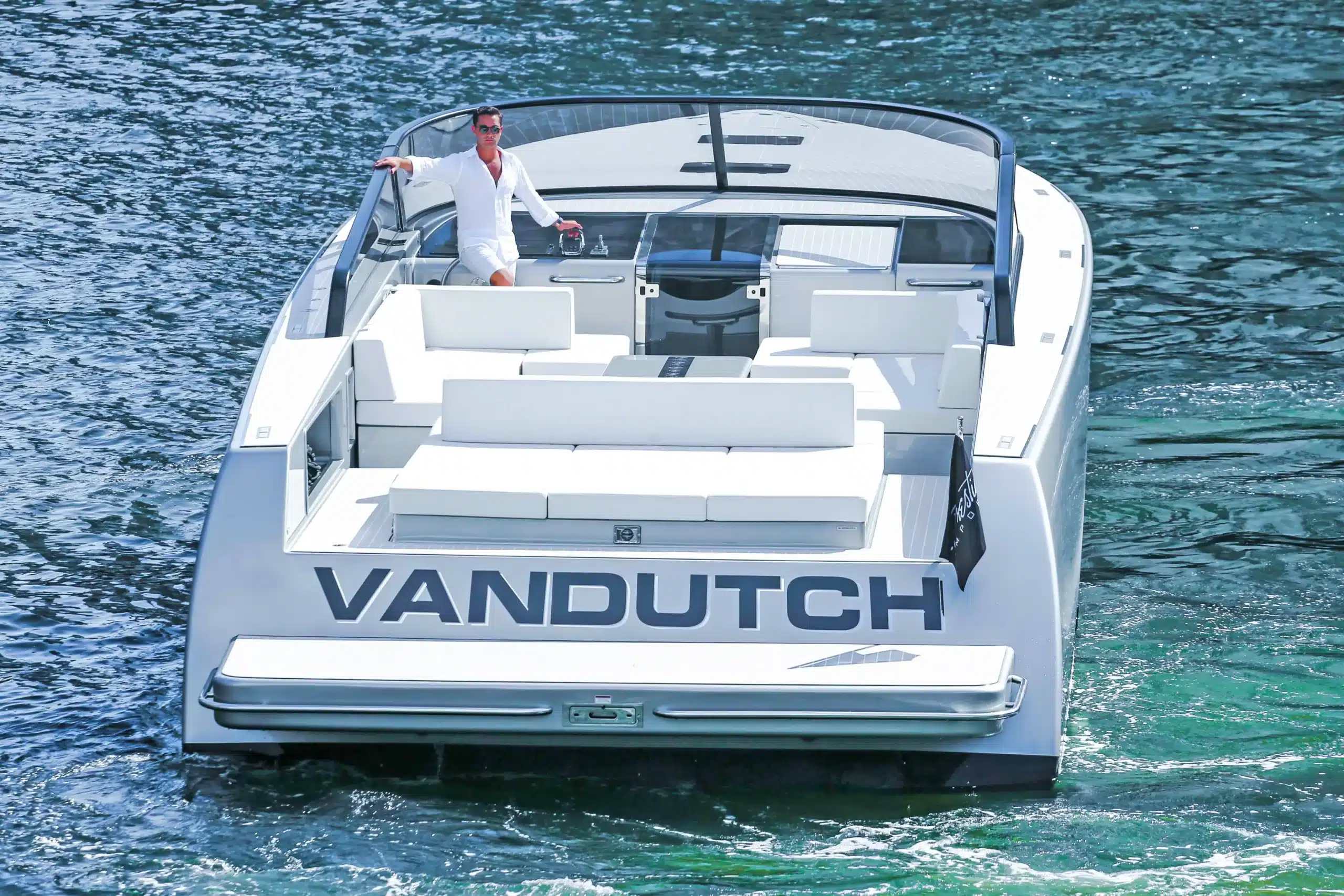 VanDutch 55 yacht cruising near St. Maarten's coastline, showcasing its sleek design and luxury features.