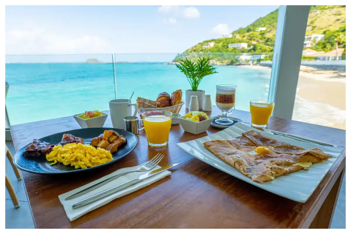 Breakfast table at Sunset Beach Café, Grand Case Beach Club, overlooking Little Bay Beach & Creole Rock, St. Martin