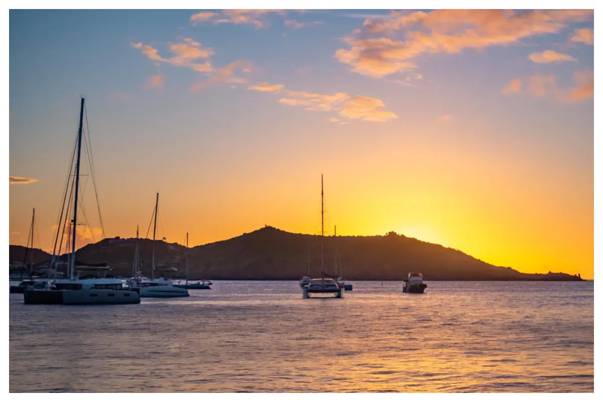 Golden sunset over Grand Case Beach Club in St. Martin, ocean reflecting warm sky colors