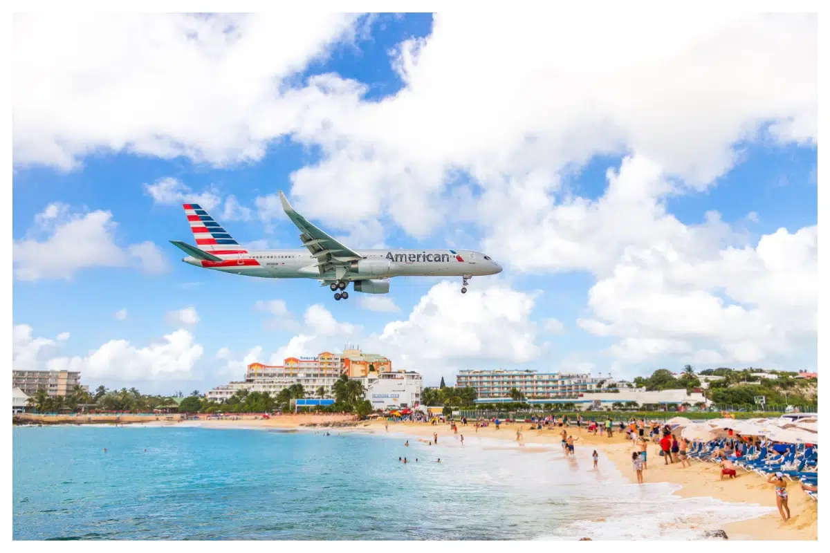 Airplane landing over Maho Beach, Sint Maarten—iconic plane spotting at Princess Juliana International Airport
