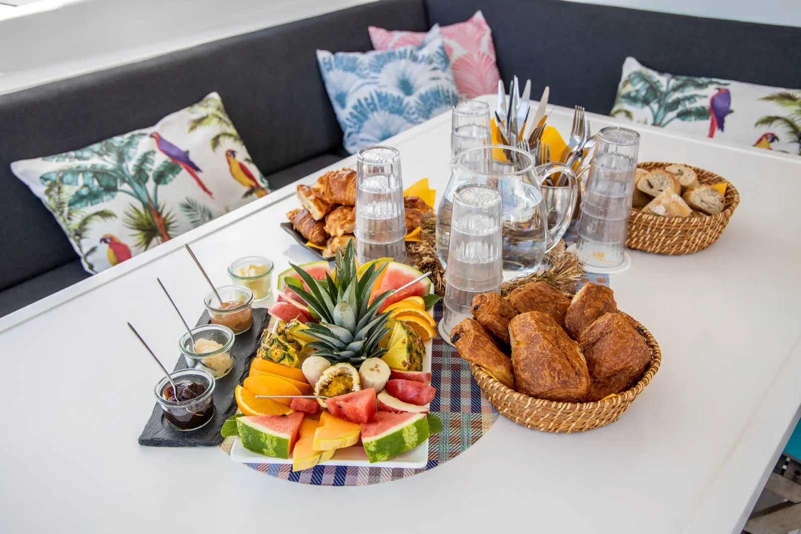 Sunlit breakfast spread aboard Ever Glorious catamaran near St. Maarten coastline