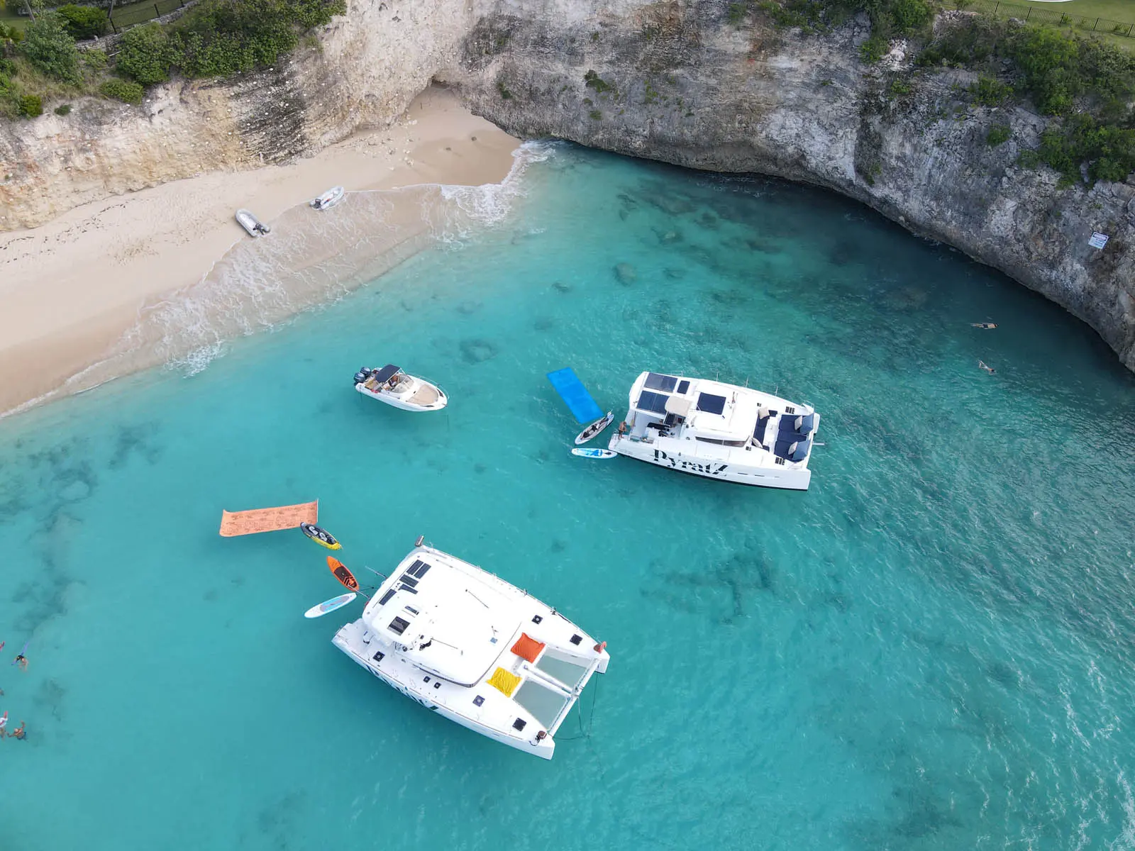 Lagoon 450S power catamaran 'Galaxy' anchored in turquoise waters off St. Maarten, featuring a romantic wedding proposal setup with rose petals and champagne