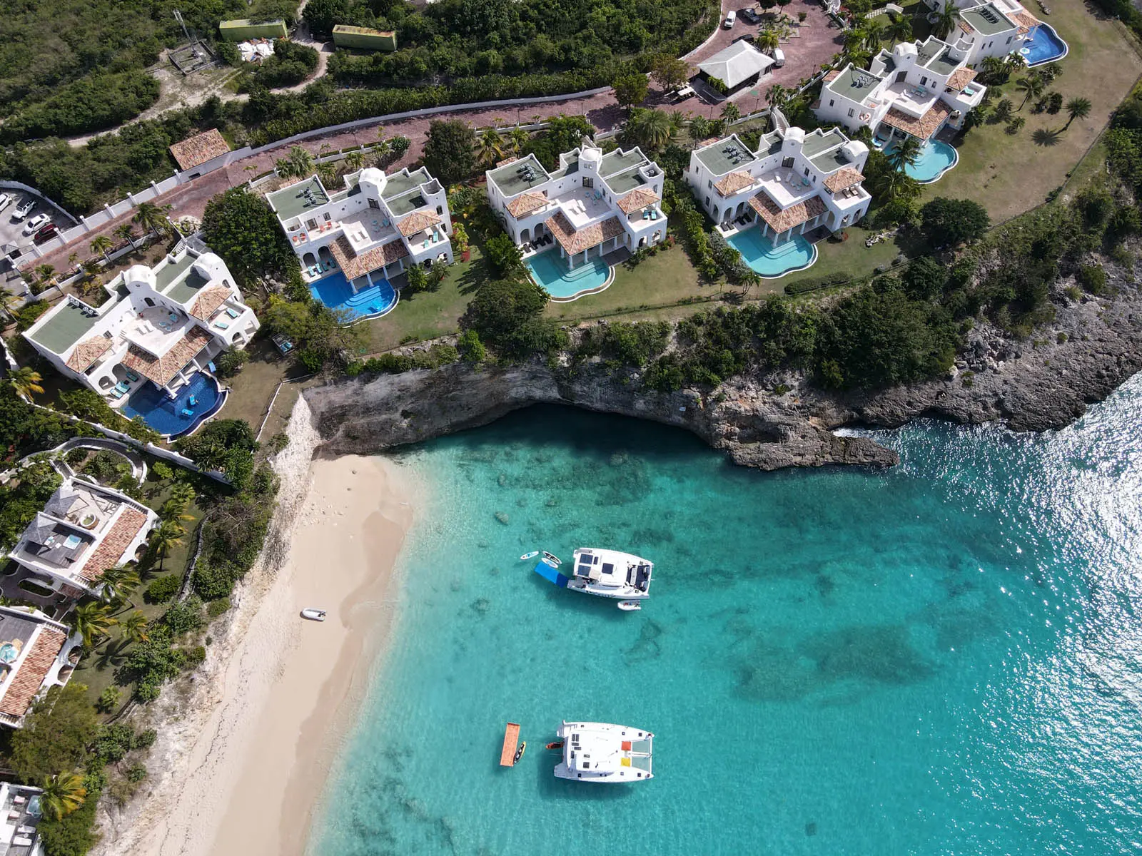 Lagoon 450S power catamaran 'Galaxy' anchored in turquoise waters off St. Maarten, showcasing paddle boards, a kayak, and a floating mat