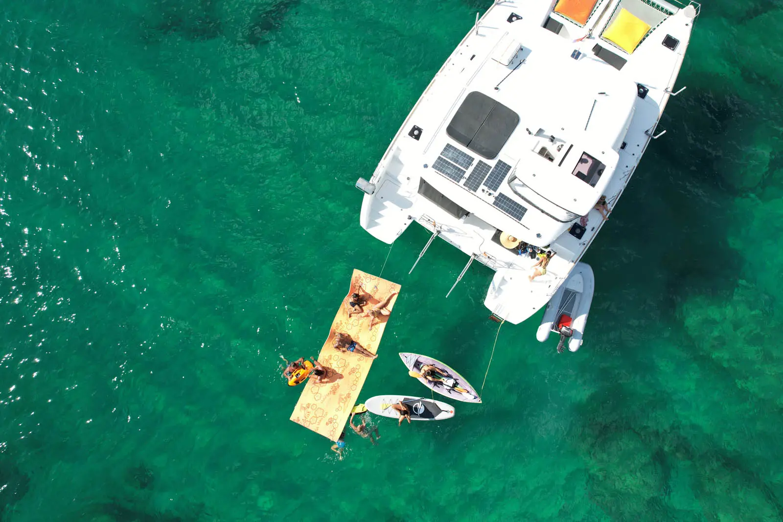 Aerial view of Lagoon 450S power catamaran 'Galaxy' anchored in turquoise waters off St. Maarten, showcasing its sleek design and spacious deck