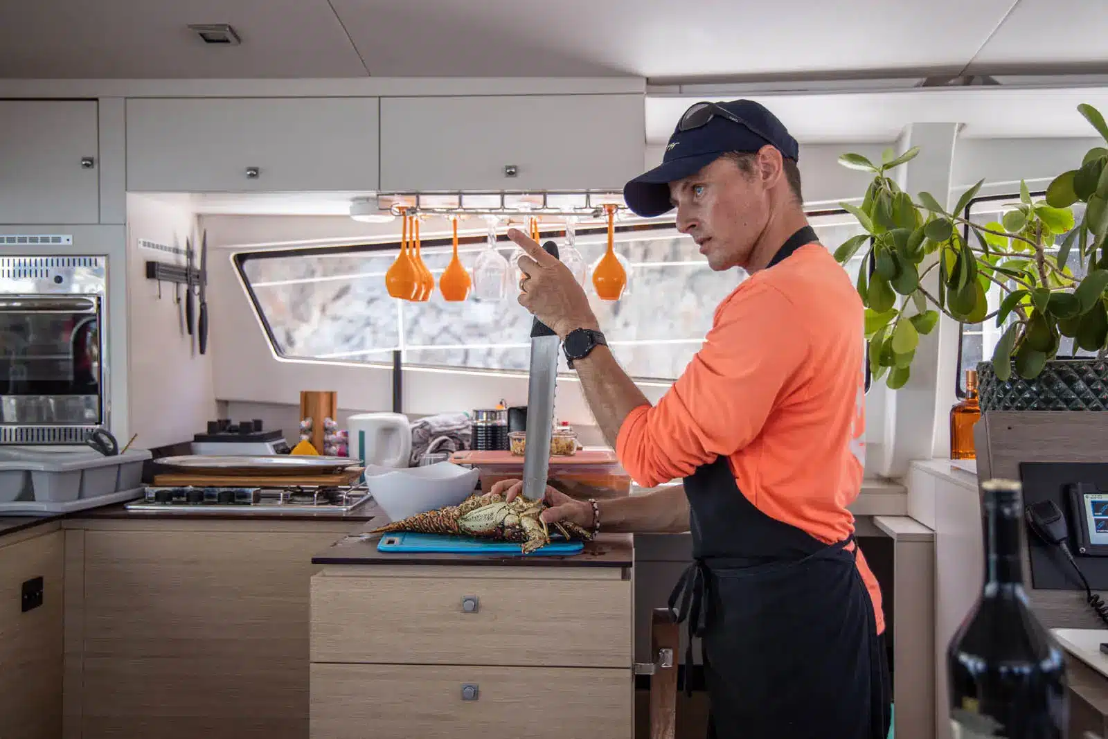 Captain preparing lobster dish for guests aboard Ever Glorious Bali 45FT catamaran in St. Maarten